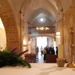 Interior de l’Església de Santiga a Santa Perpètua de Mogoda, vista des de l’altar amb visitants al fons, espai romànic visitable
